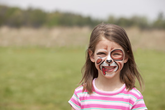 girl with face painted as a dog