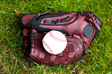 Baseball glove and ball on the grass