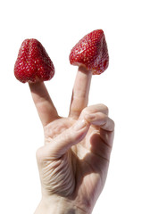 two strawberries strung on two fingers