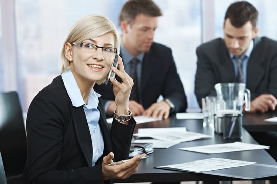 Businesswoman on phone at meeting