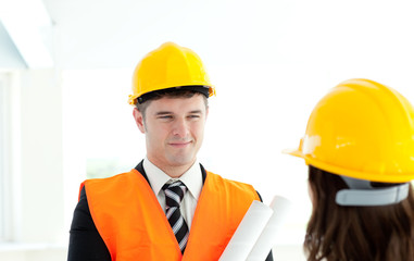 Happy architect discussing with his colleague