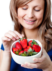 Caucasian woman eating strawberries