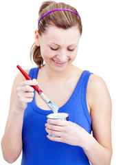 Happy woman using a paintbrush