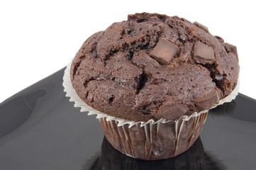 chocolate muffin on black plate