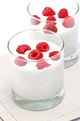 Glass of delicious yoghurt musli with raspberries