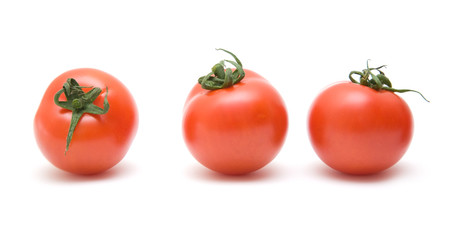 three ripe red tomatoes in a row; isolated on white background