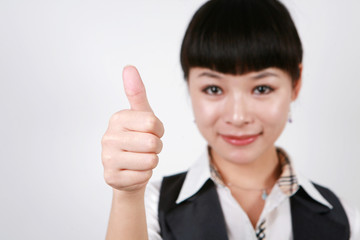 Businesswoman giving thumbs up for approval