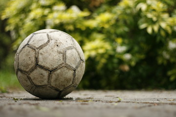 Fototapeta na wymiar Old football in the garden patio