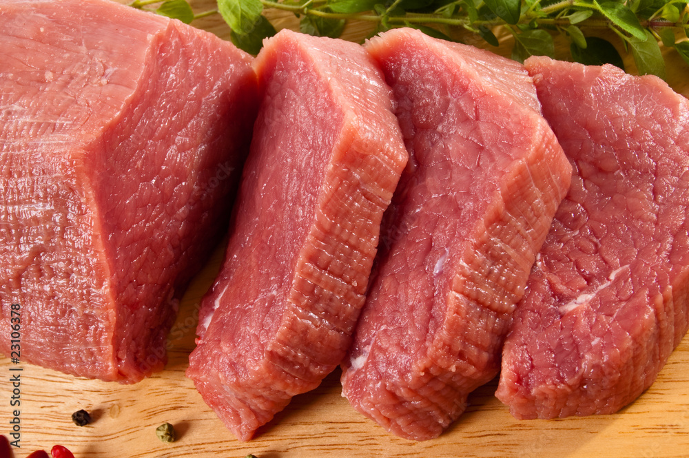 Wall mural raw beef on cutting board isolated on white background