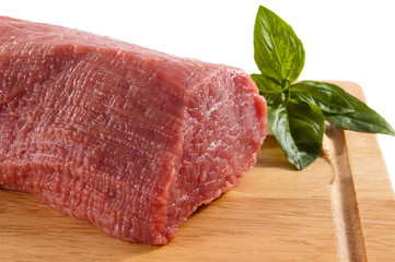 Raw beef on cutting board isolated on white background