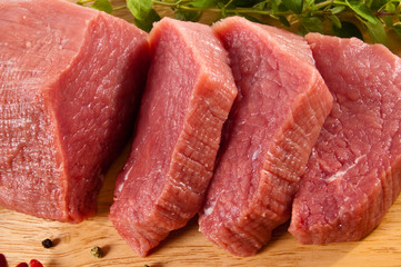 Raw beef on cutting board isolated on white background
