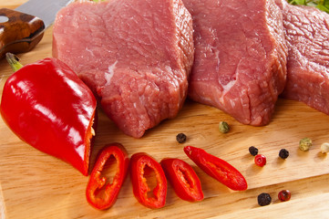 Raw beef on cutting board isolated on white background
