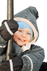 Cheerful little girl on rope swing on a winter day