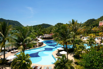 View to swimming pool and garden in tropical resort.