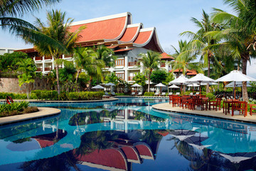 Exotic building and swimming pool in tropical resort.