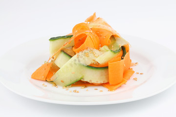 Carrot and cucumber salad with sesame seeds and olive oil