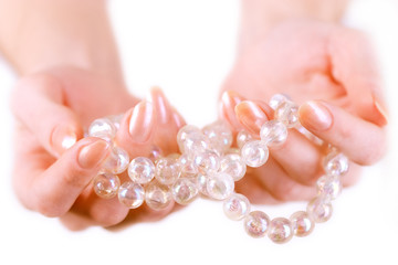 girl holding white pearl beads