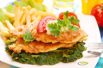 fish on spinach with fries