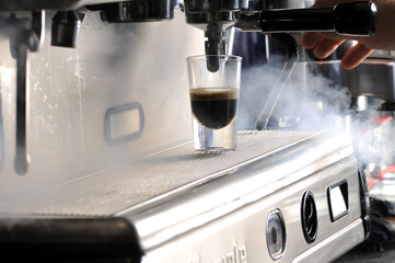 Espresso machine making a cup of coffee with steam