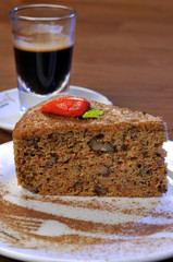 Carrot cake and an espresso at the background.