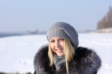 face beauty girl with blonde hair outdoors, in a fur coat