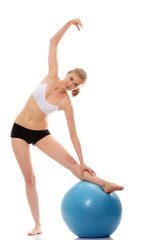 Fototapeta premium Woman exercising with fitness ball