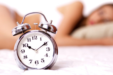 Alarm clock with and beautiful woman in white bikini
