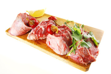 uncooked meat medallion on wood