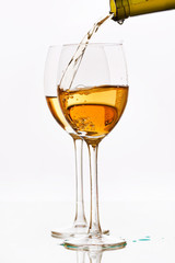 White wine pouring down from a wine bottle
