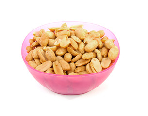 pink bowl with salted peanuts over white background
