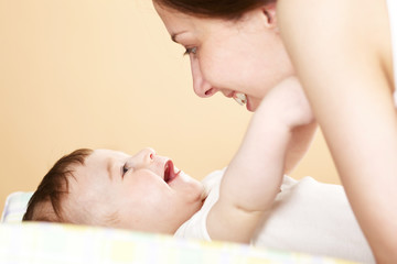 mother with her baby boy playing