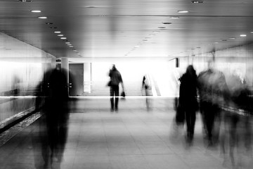 motion blurred of people walking in subway.