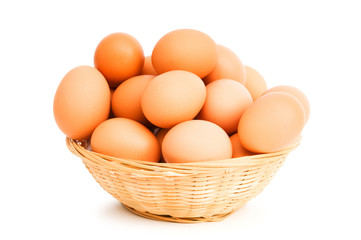 Brown eggs in the basket on white