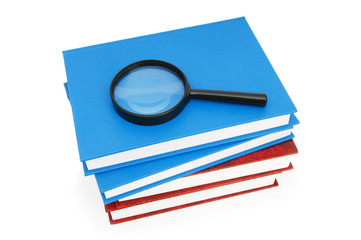 Magnifying glass over the stack of books