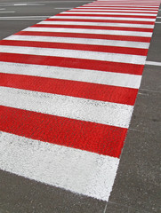 red pedestrian sign on asphalt road