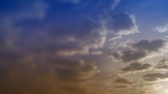 Timelapse clouds in blue and yellow sky. HD 1080p.