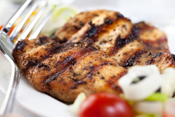 Marinated and grilled chicken breast with salad