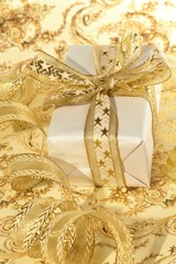 Beautiful gift box on the gold background