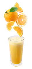 Slices of orange fall into a glass of fresh juice