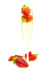 strawberries in a glass of champagne isolated on white
