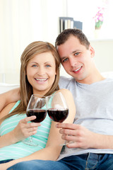 Portrait of a happy young couple drinking red wine