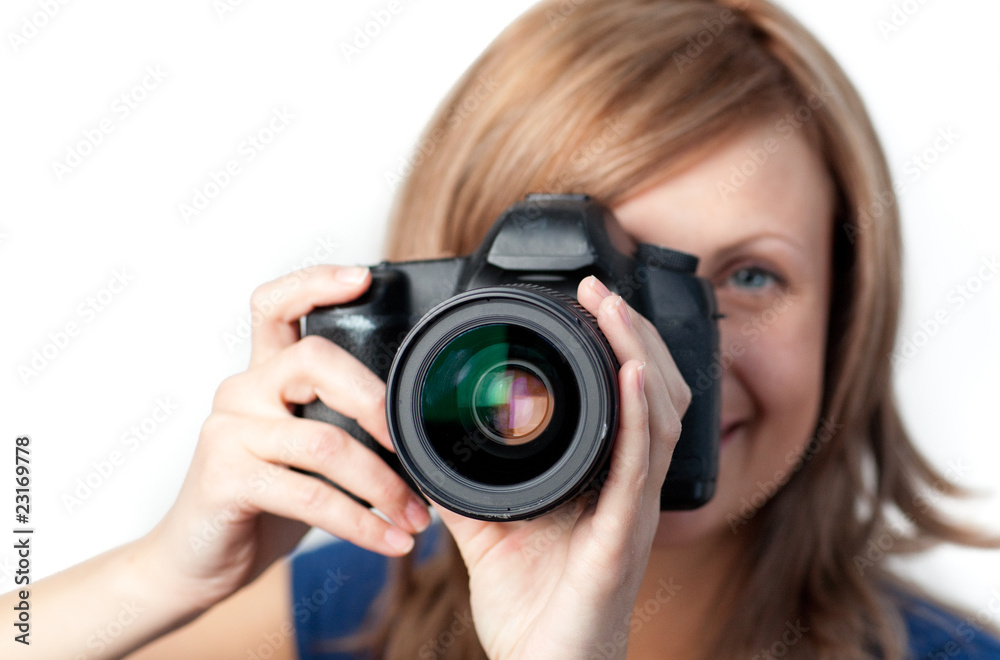 Wall mural Attractive woman using a camera