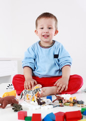 Lovely boy playing with blocks