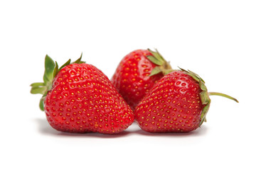 Three fresh strawberries isolated on white background