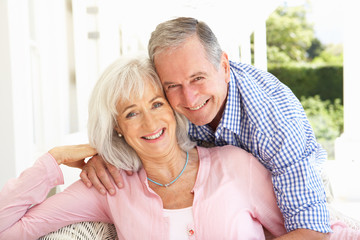 Portrait Of Senior Couple Relaxing Together On Sofa