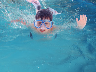 child swimming with diving mask and flippers