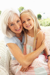 Portrait Of Grandmother With Granddaughter Relaxing Together