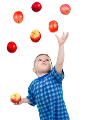 Fototapeta na wymiar Little boy caughts flying apple