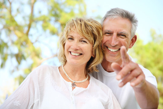 Close-up portrait of a mature couple smiling.