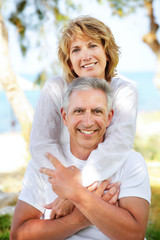 Close-up portrait of a mature couple smiling and embracing.